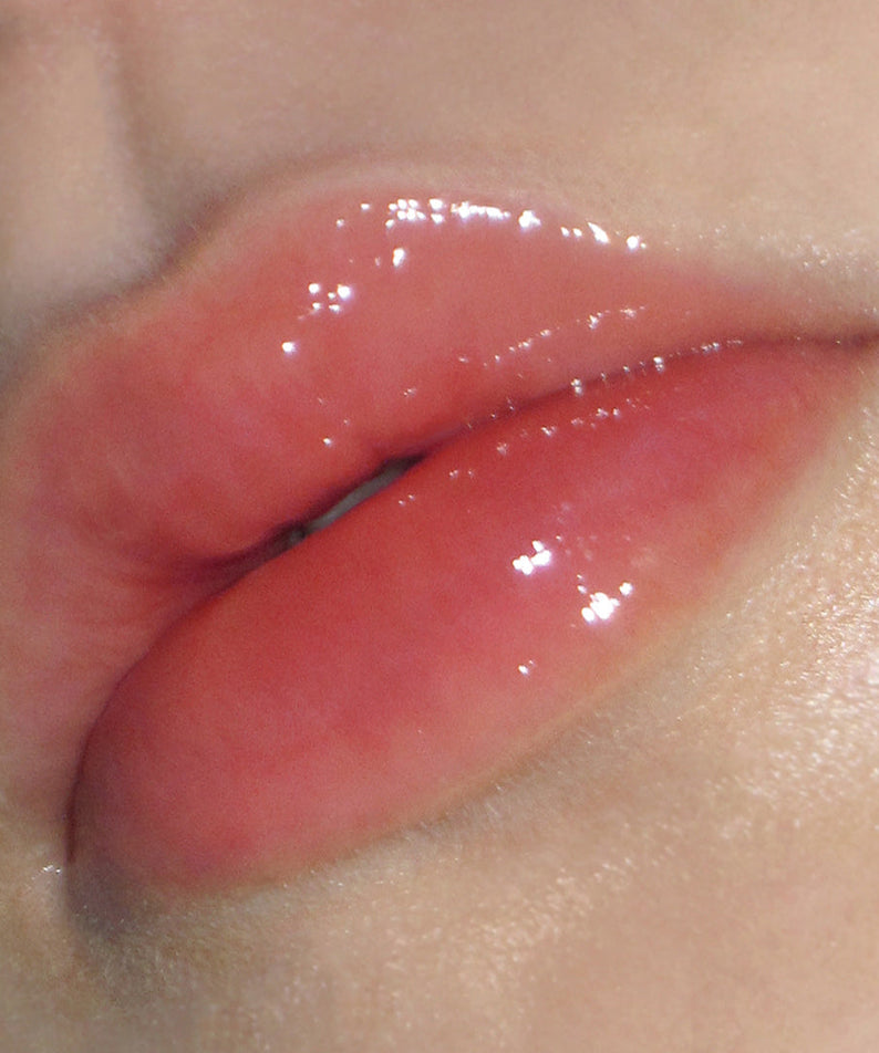 Close-up of glossy lips using DERMATORY Hyaluronic Peptide Lip Keyring, showing hydration and shine.