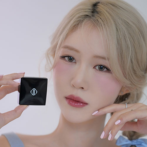 Person holding DINTO Be My Wendy Blusher with soft pink makeup.