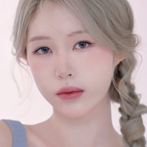 Model wearing makeup featuring DINTO Be My Wendy Blusher, showcasing soft pink hue on cheeks.