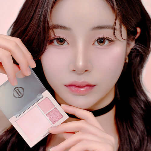 Model holding DINTO Cheek & Eye Multi-Use Palette with pink shades for versatile makeup looks.