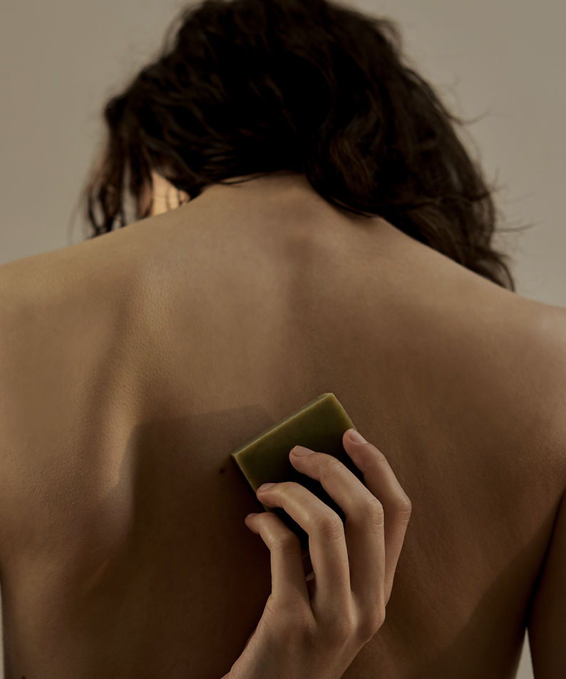Person using DONGGUBAT Dream Soap Lattuce on back for skincare