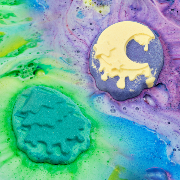 Vibrant DONGGUBAT Feild Relaxing Moment Bath Bomb Bath Set amidst colorful bathwater, featuring moon and tree-shaped bath bombs.