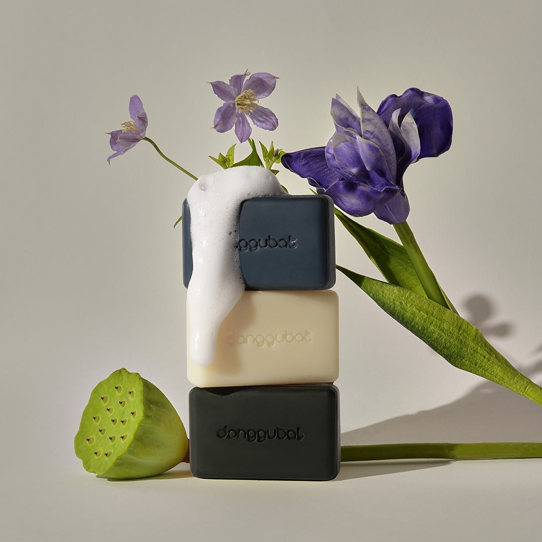 DONGGUBAT Field Blooming Perfume Shampoo Bar Repair 80g displayed with flowers and bubbles, showcasing a luxurious eco-friendly hair care product.