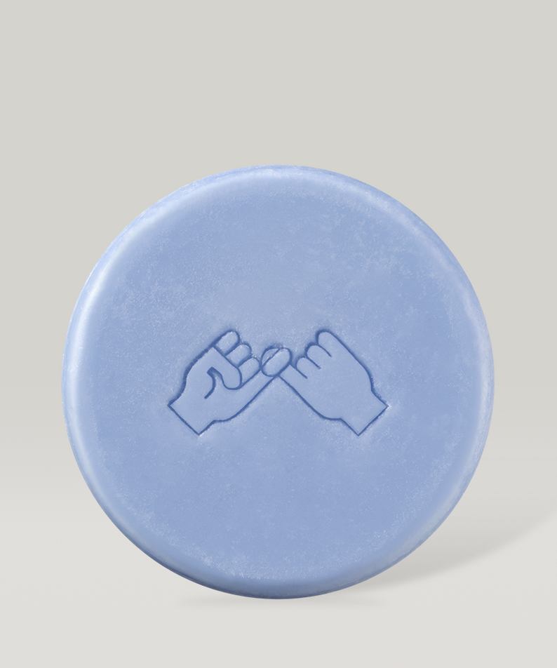 Blue DONGGUBAT Field Correct Rinse Bar with embossed design against a neutral background.