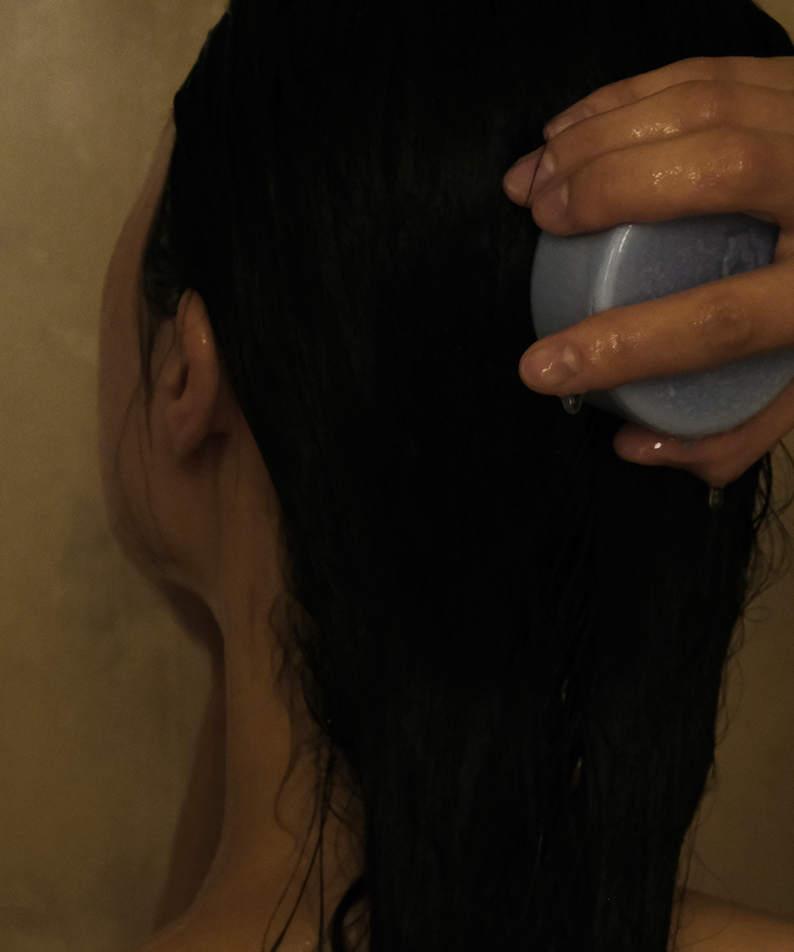 Person using DONGGUBAT Field Correct Rinse Bar in the shower for effective hair care