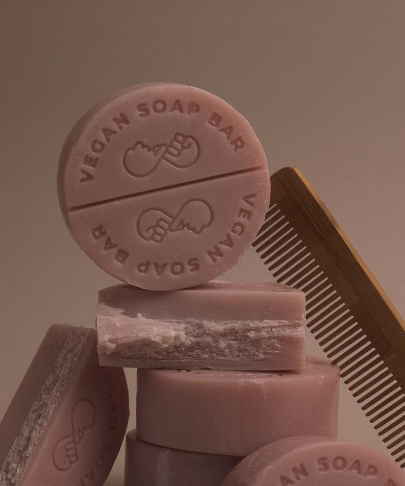 DONGGUBAT Vegan Shampoo Bar Dongbaek stacked with vegan soap bars and a wooden comb in a minimalist setting.