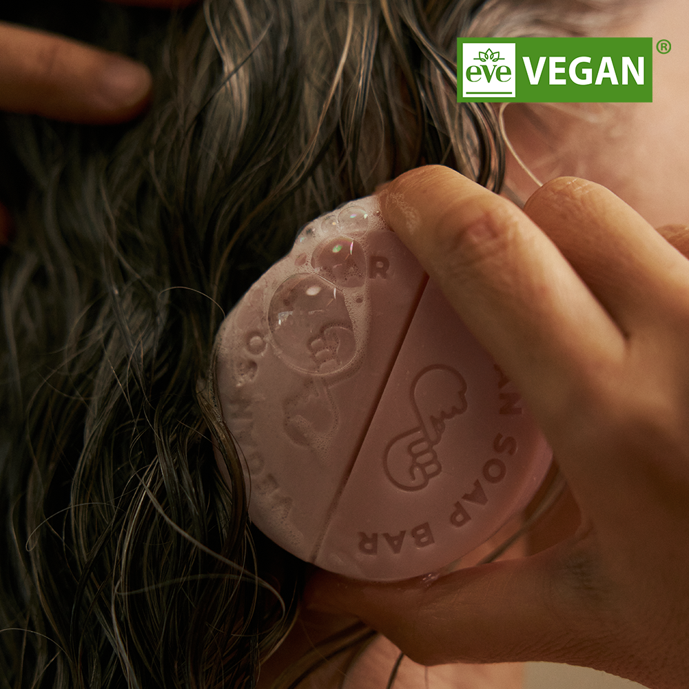 Using DONGGUBAT Vegan Shampoo Bar Dongbaek on wet hair for effective cleansing.