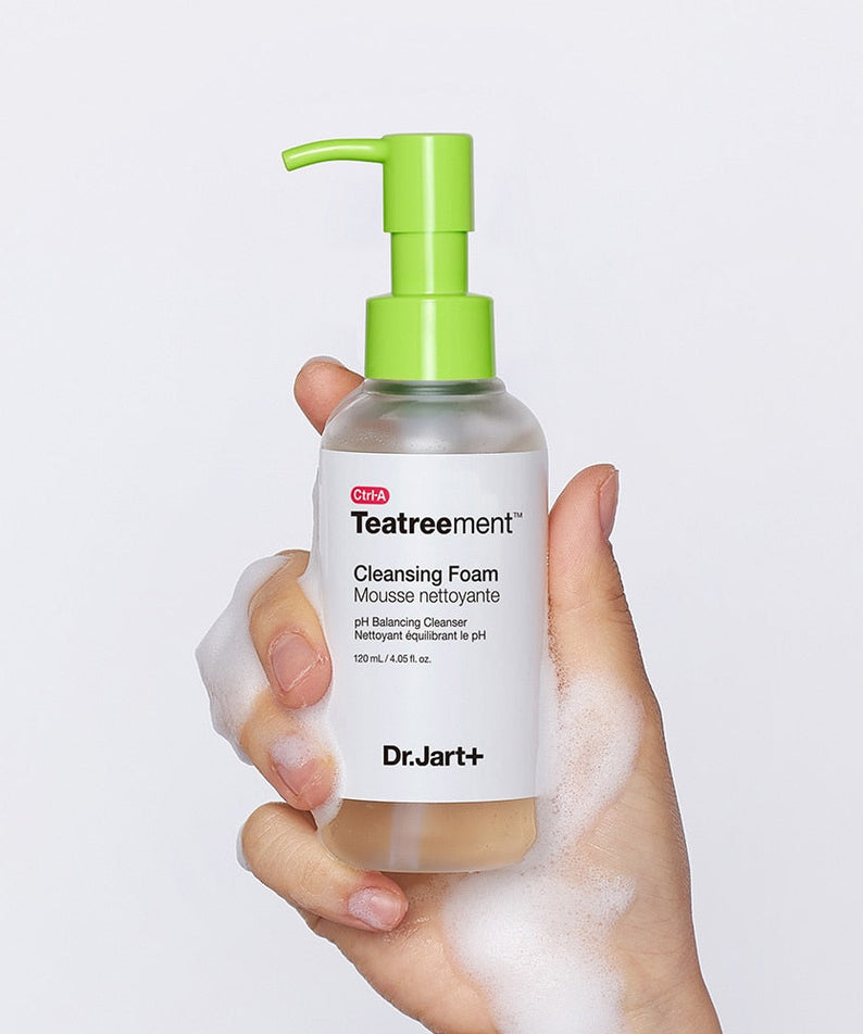 Hand holding DR. JART+ Ctrl-A Teatreement Cleansing Foam 120ml bottle with foamy texture