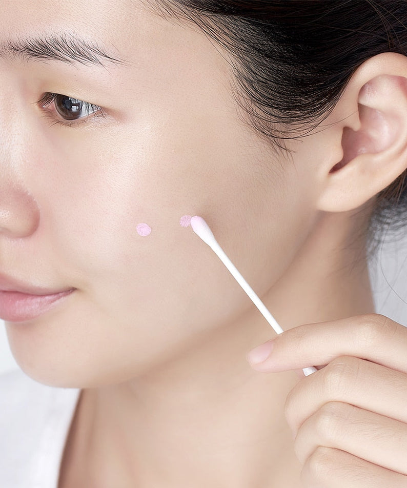 Applying DR. JART+ Ctrl-A Teatreement Soothing Spot 15ml with cotton swab to face for targeted skincare treatment
