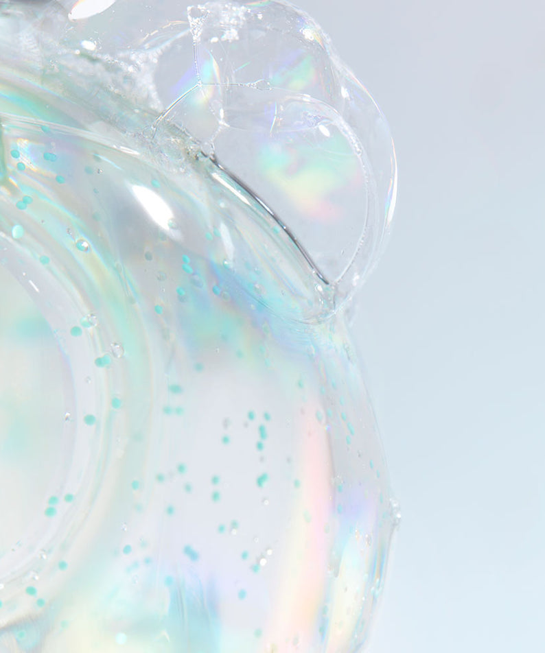 Close-up of DR. JART+ Pore Remedy Renewing Foam Cleanser 150ml texture with iridescent bubbles