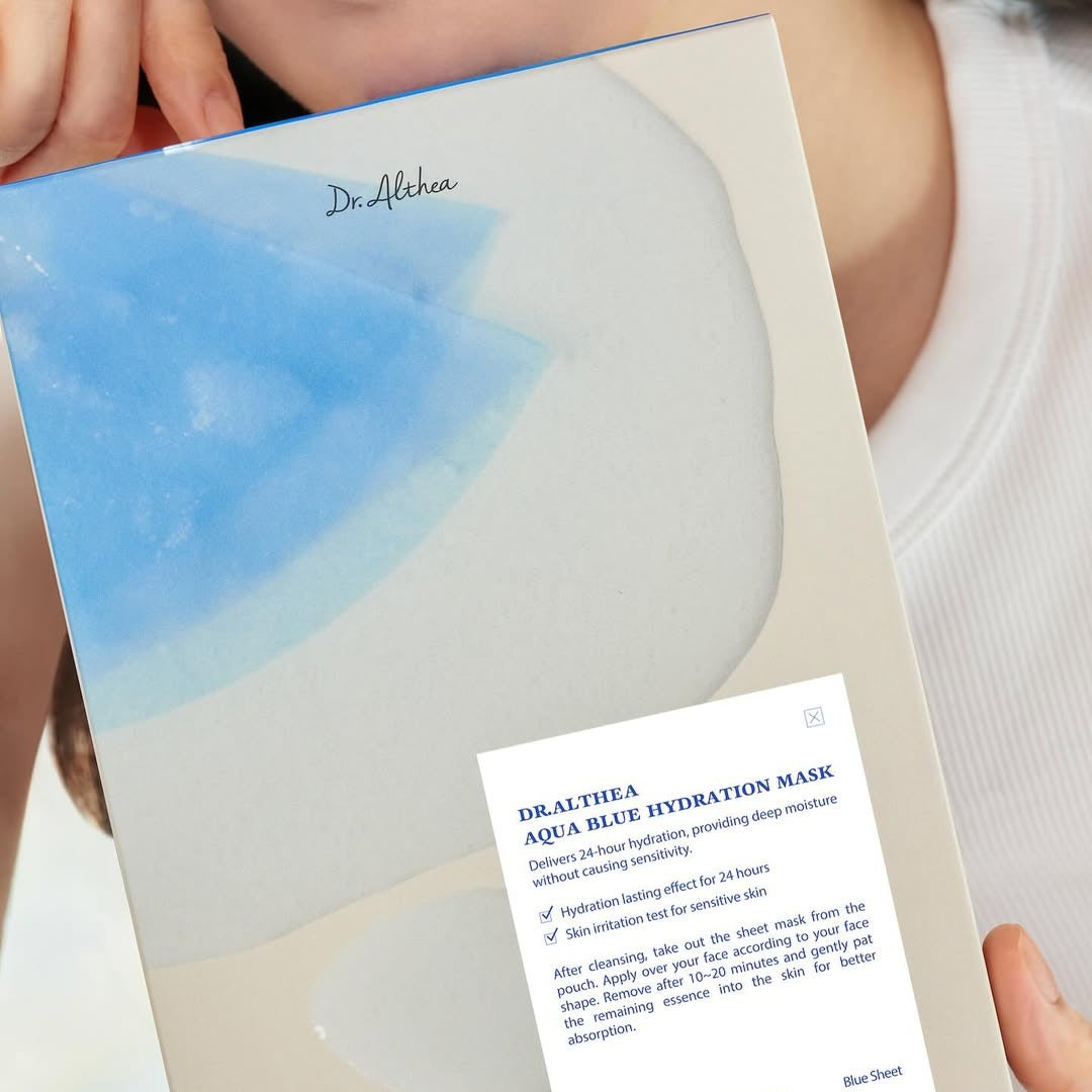 DR.ALTHEA Aqua Blue Hydrating Mask (4ea) package held by person, showcasing premium hydration skincare product.