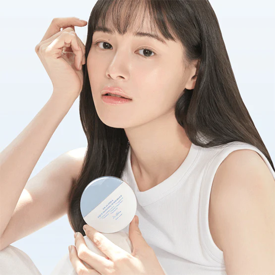 Woman holding DR.ALTHEA Aqua Glowing Sunscreen 45ml, highlighting luminous skin.