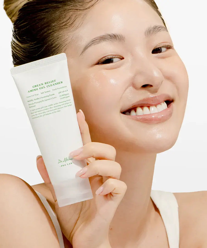 Smiling woman holding DR.ALTHEA Green Relief Amino Gel Cleanser 100ml tube