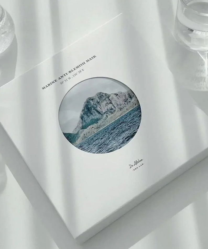 DR.ALTHEA Marine Anti Blemish Mask (5ea) packaging with ocean and mountain design on a sunlit surface.