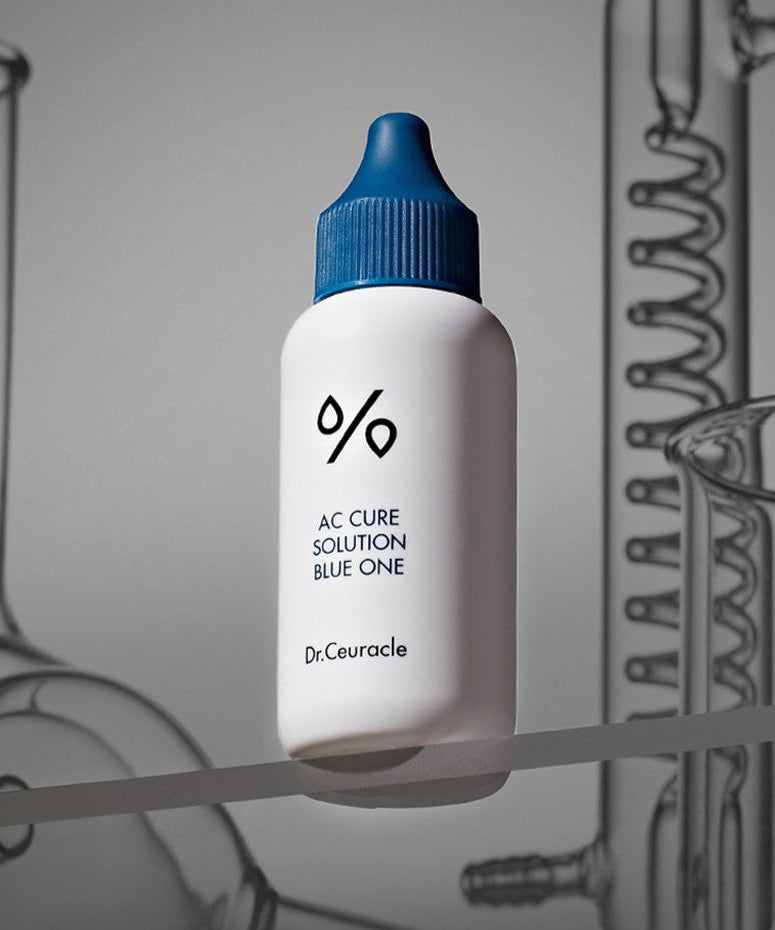 DR.CEURACLE AC Cure Solution Blue One 50ml with focus on the bottle against a scientific background.