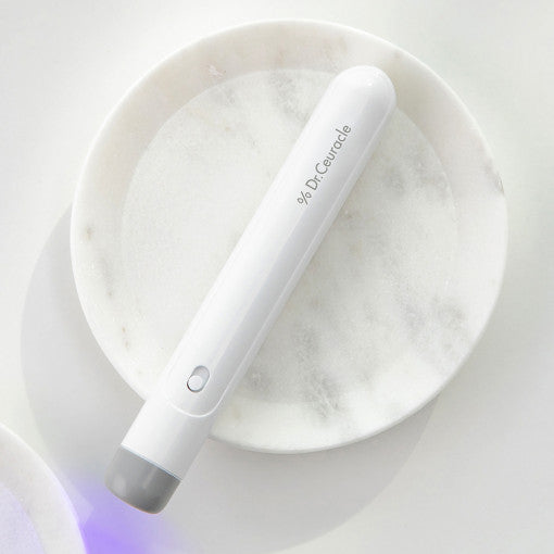 DR.CEURACLE AC Spot Healer on a round marble dish for targeted skin treatment