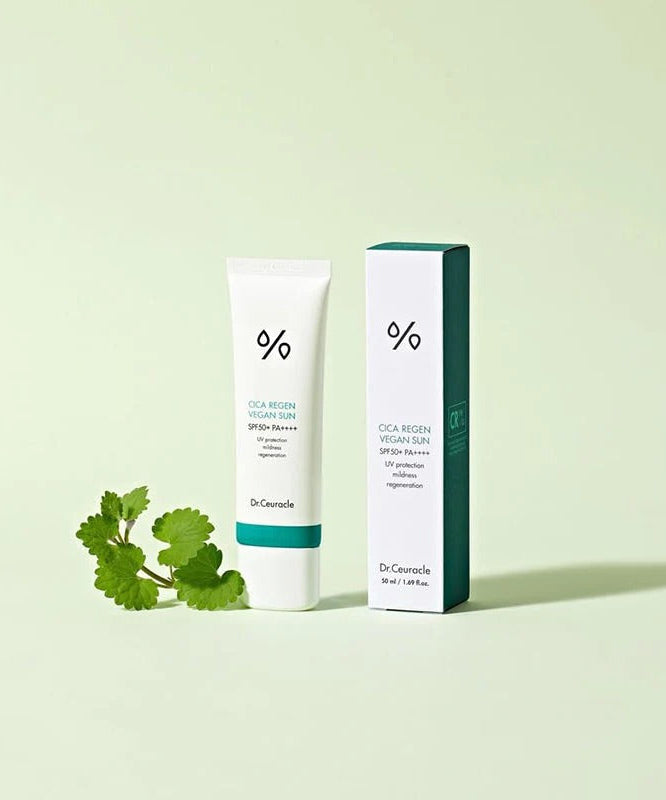 DR.CEURACLE Cica Regan Vegan Sun SPF50+PA++++ 50ml sunscreen product image with packaging and cica plant on light green background