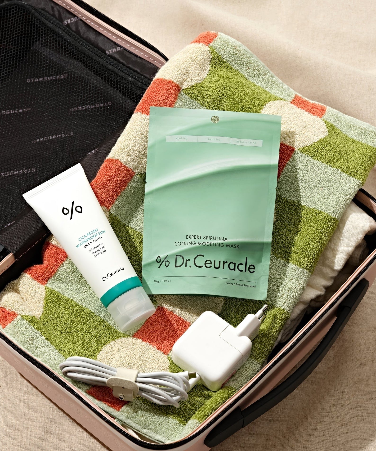 DR.CEURACLE Expert Spirulina Cooling Modeling Mask 30g in a travel bag with accessories and a colorful towel.