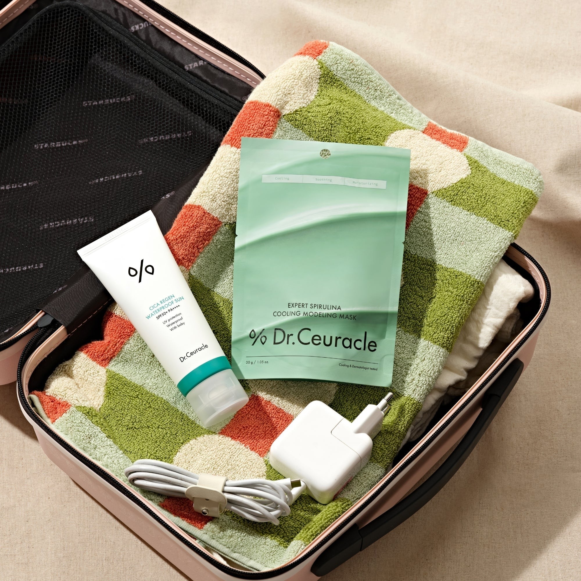 DR.CEURACLE Expert Spirulina Cooling Modeling Mask 30g in a travel bag with accessories and a colorful towel.