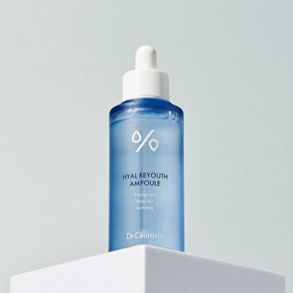 DR.CEURACLE Hyal Reyouth Ampoule 50ml in blue bottle with dropper on white pedestal for skincare routine.