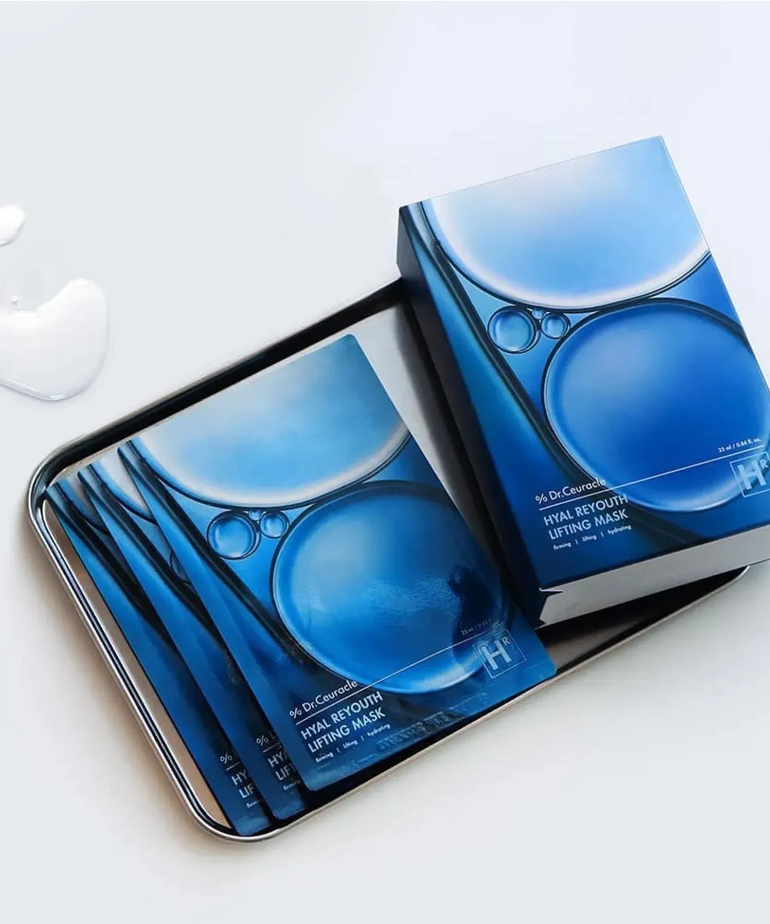 DR.CEURACLE Hyal Reuse Lifting Mask (10EA) packaging on a tray with liquid drops