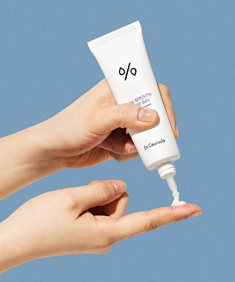 Applying DR.CEURACLE Hyal Reyutsu Moist Sun SPF50+,PA++++ sunscreen on hand.