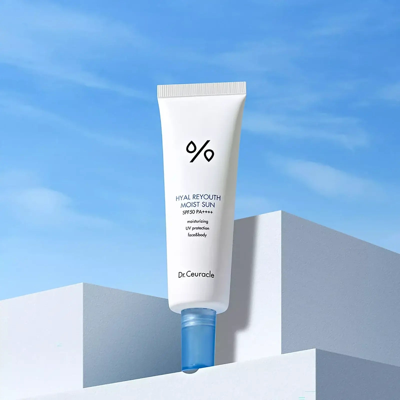 DR.CEURACLE Hyal Reyutsu Moist Sun SPF50+,PA++++ tube on geometric background with blue sky
