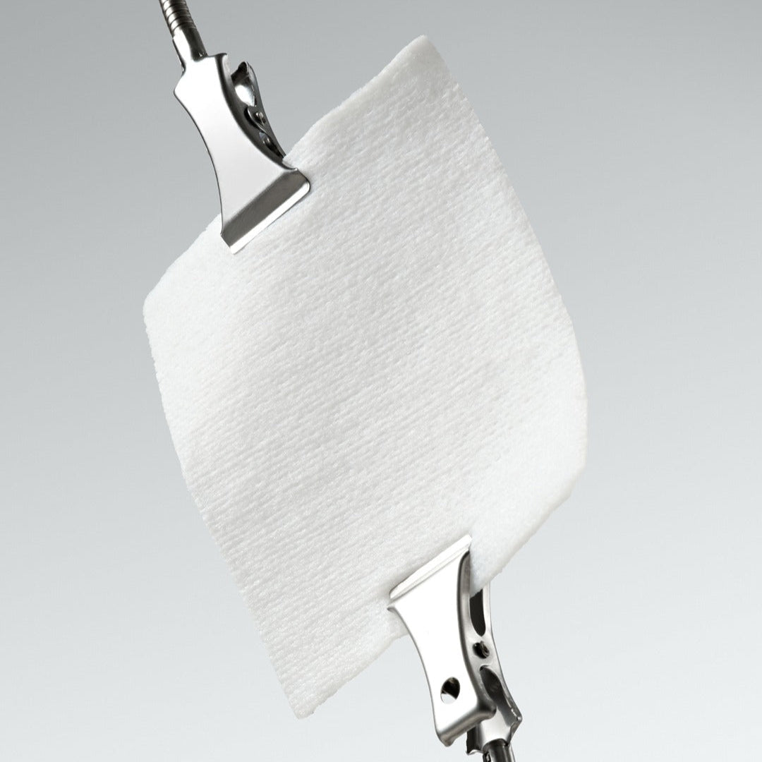Close-up of DR.CEURACLE PLC Calming Solution Pad 130 pads with metal clips demonstrating texture