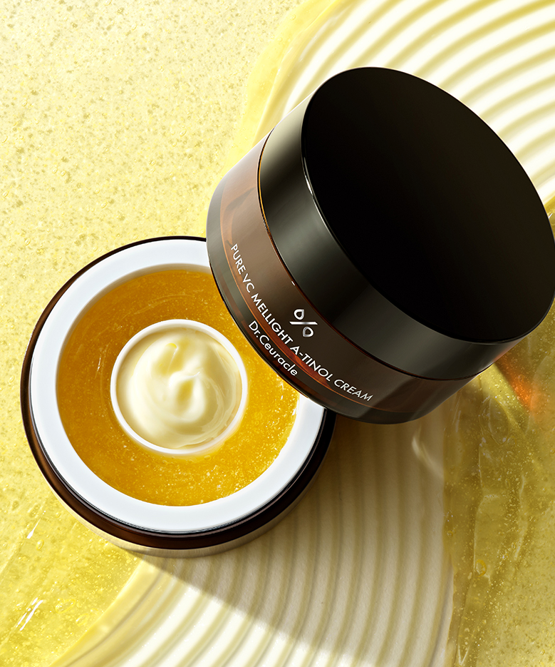 Open jar of DR.CEURACLE Pure VC Mellight A-Tinol Cream 70g on textured background
