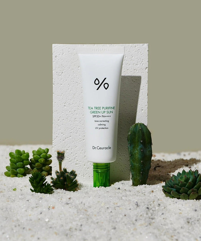 DR.CEURACLE Tea Tree Purifine Green Sup Sun 50ml sunscreen with greenery in sand background