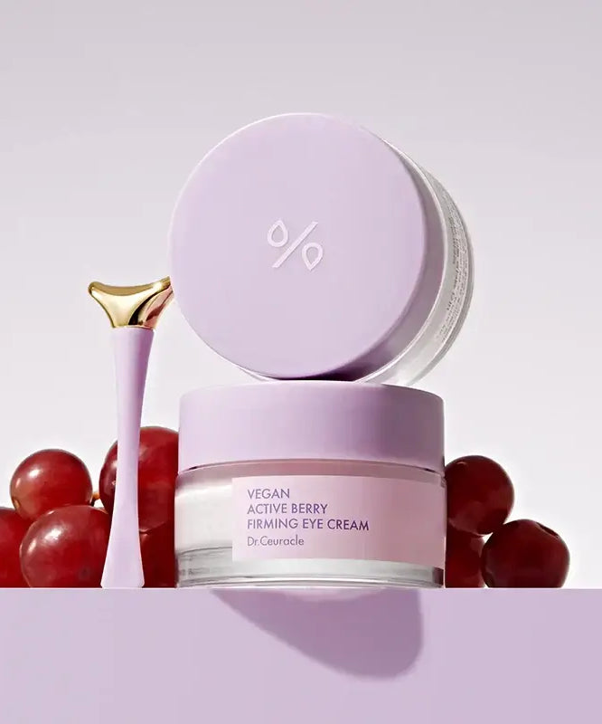 DR.CEURACLE Vegan Active Berry Firming Eye Cream with purple packaging, surrounded by berries and skincare applicator.