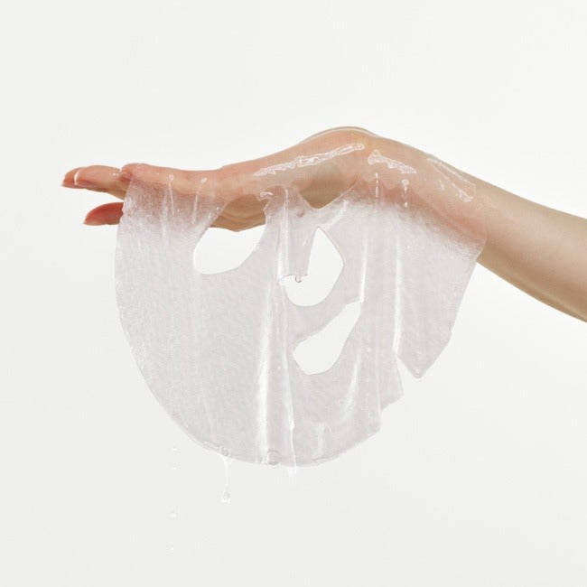 Hand holding a DR.G Red Blemish Cool Collagen Elasticity Mask 10 Sheets showing texture and transparency.