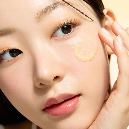 Woman applying DR.G Vita Clear Sun Serum 50ml on her face for skincare.