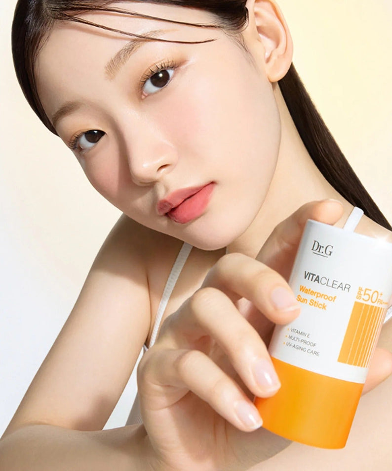 Woman holding DR.G Vita Clear Waterproof Sun Stick 21g showing product texture and packaging.