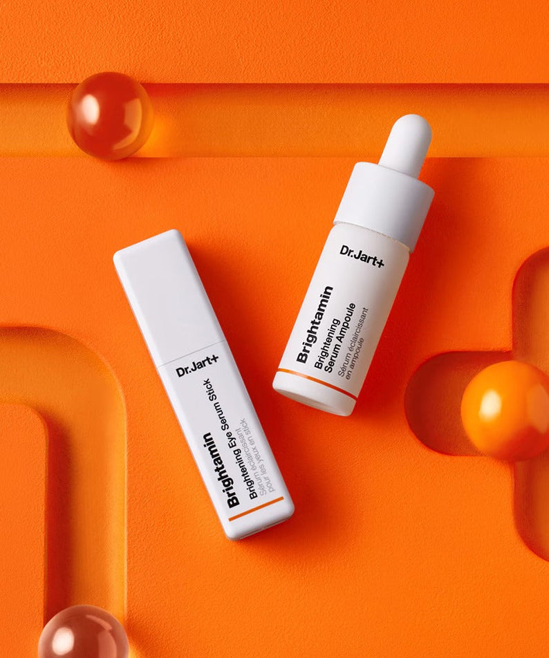 DR.JART+ Brightamine Brightening Serum Ampoule on vibrant orange background.