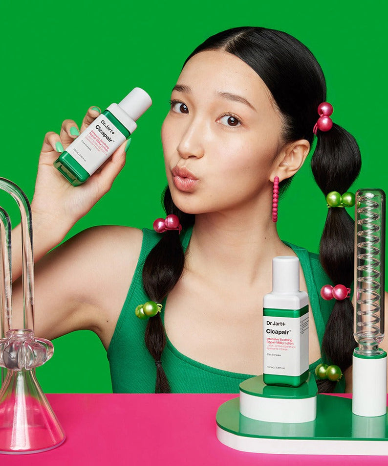 Woman holding DR.JART+ Cicapair Intensive Soothing Repair Milky Lotion 100ml in a vibrant lab setting