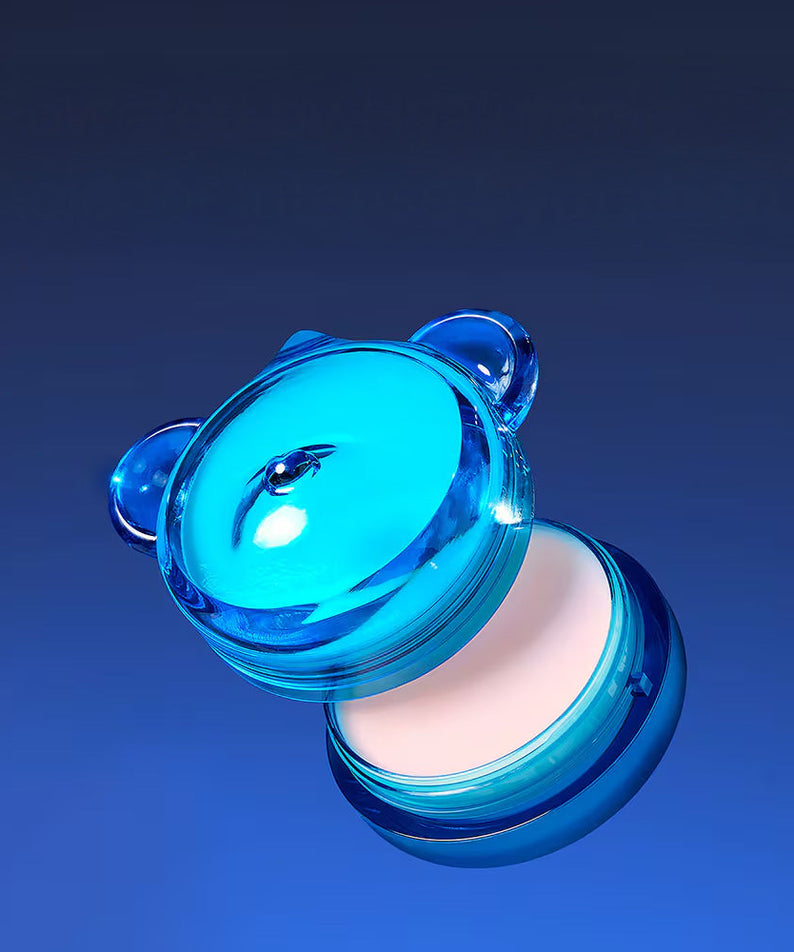Bright blue container of DR.JART+ Vital Hydra Solutionâ„¢ Hydrating Lip Mask against a dark gradient background