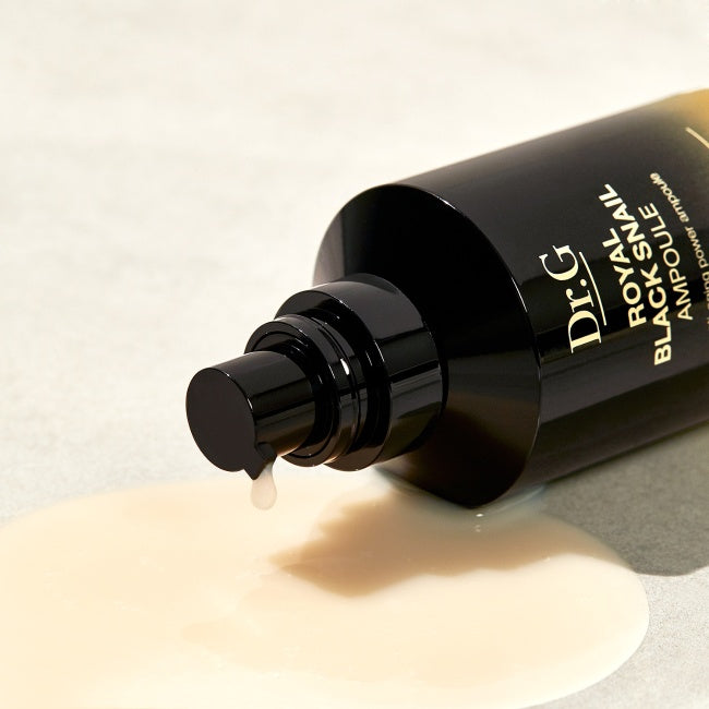 Dr.G Royal Black Snail Ampoule 30ml bottle with spilled serum on surface, highlighting product texture and packaging.