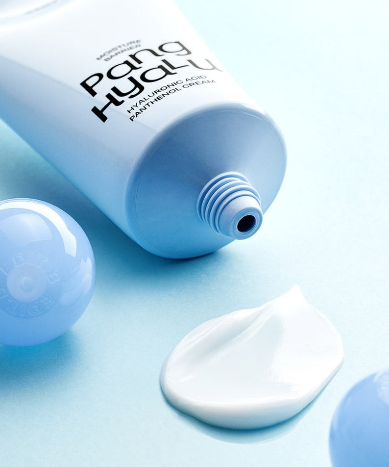 EDIT.B Moisture Barrier Pang Hyaluronic Acid Pathenol Cream 100ml tube and cream texture on a blue background.