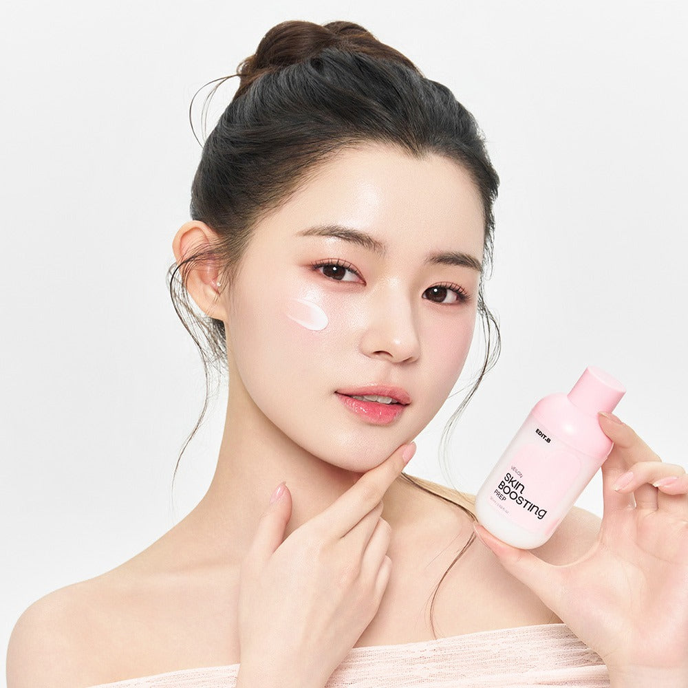 EDIT.B Veil On Skin Boosthing Prep 50ml held by model, showcasing application on cheek.