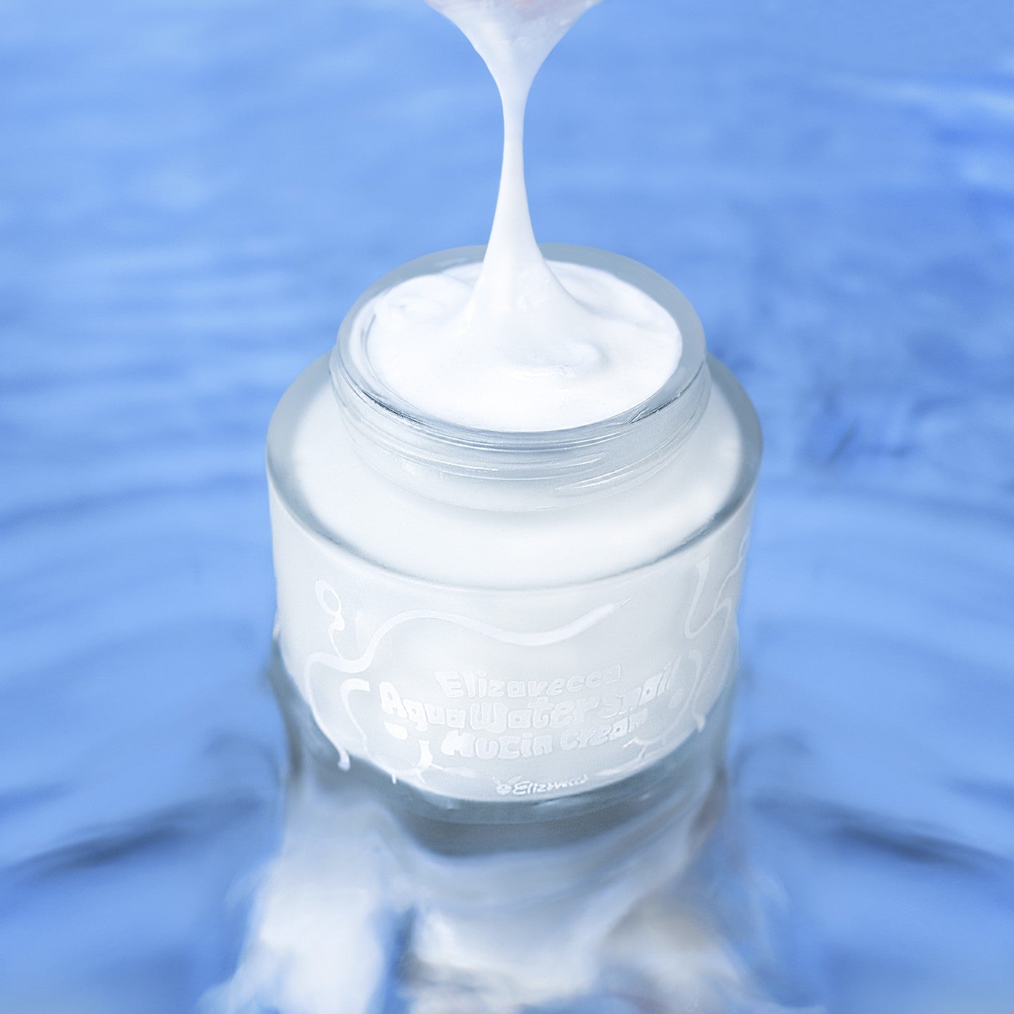 ELIZAVECCA Aqua Water Snail Mushine Cream jar with creamy texture on blue background