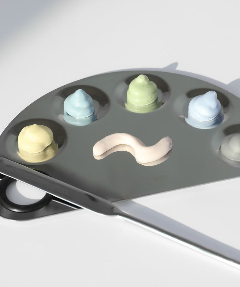 ELIZAVECCA Modeling Pack Face Mask 6 Types shown on a palette with assorted colors, highlighting the variety of skincare options.