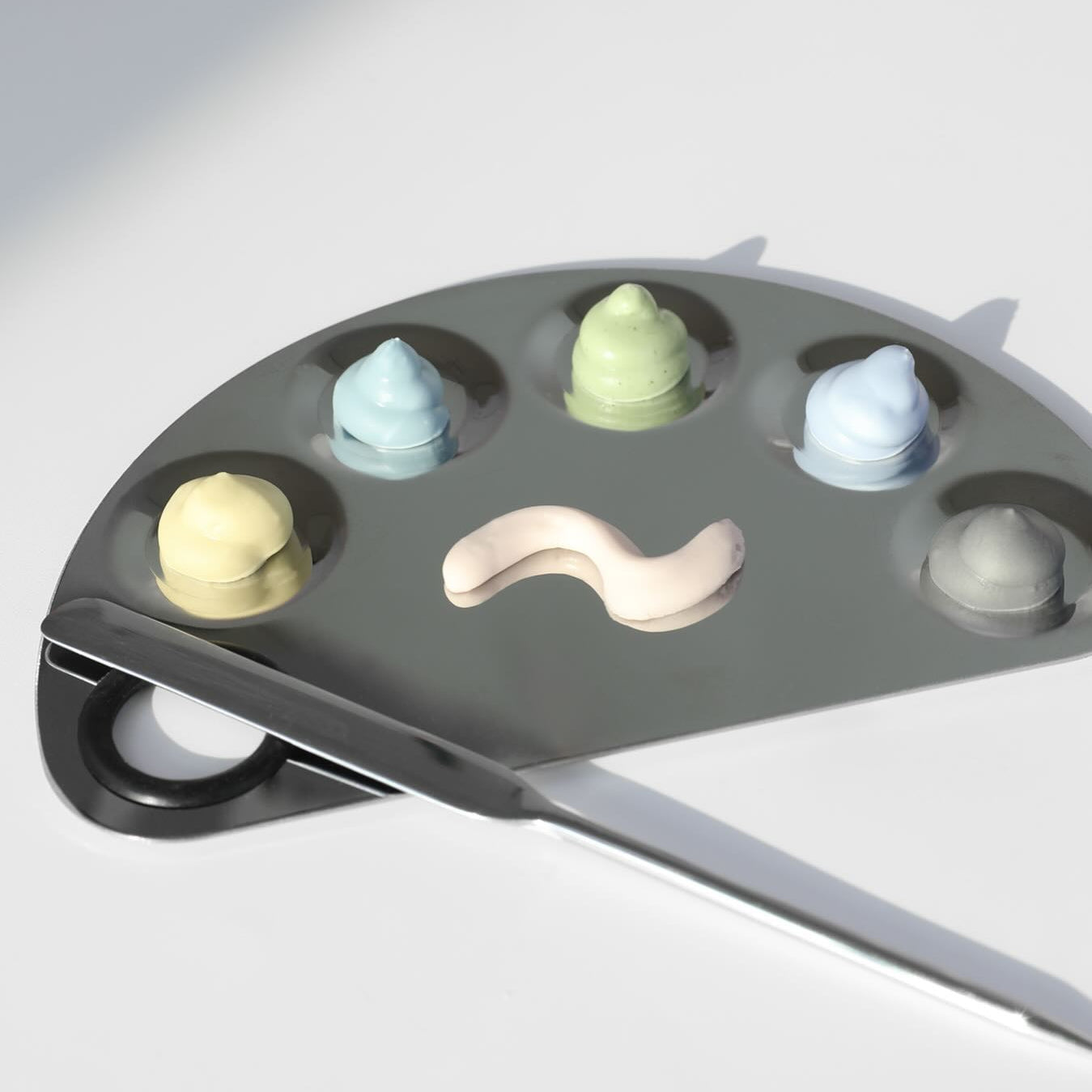 ELIZAVECCA Modeling Pack Face Mask 6 Types shown on a palette with assorted colors, highlighting the variety of skincare options.