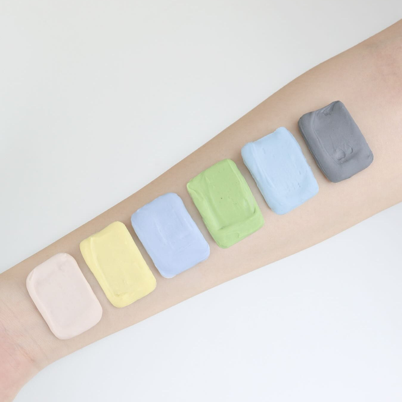 ELIZAVECCA Modeling Pack Face Mask 6 Types displayed on an arm, showcasing diverse colors for beauty treatment.