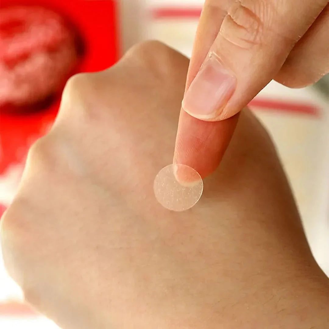 Close-up of a hand picking up ELIZAVECCA Witch Piggy Hell-Pore Blemish Spot Patch 44 EA for skincare use.