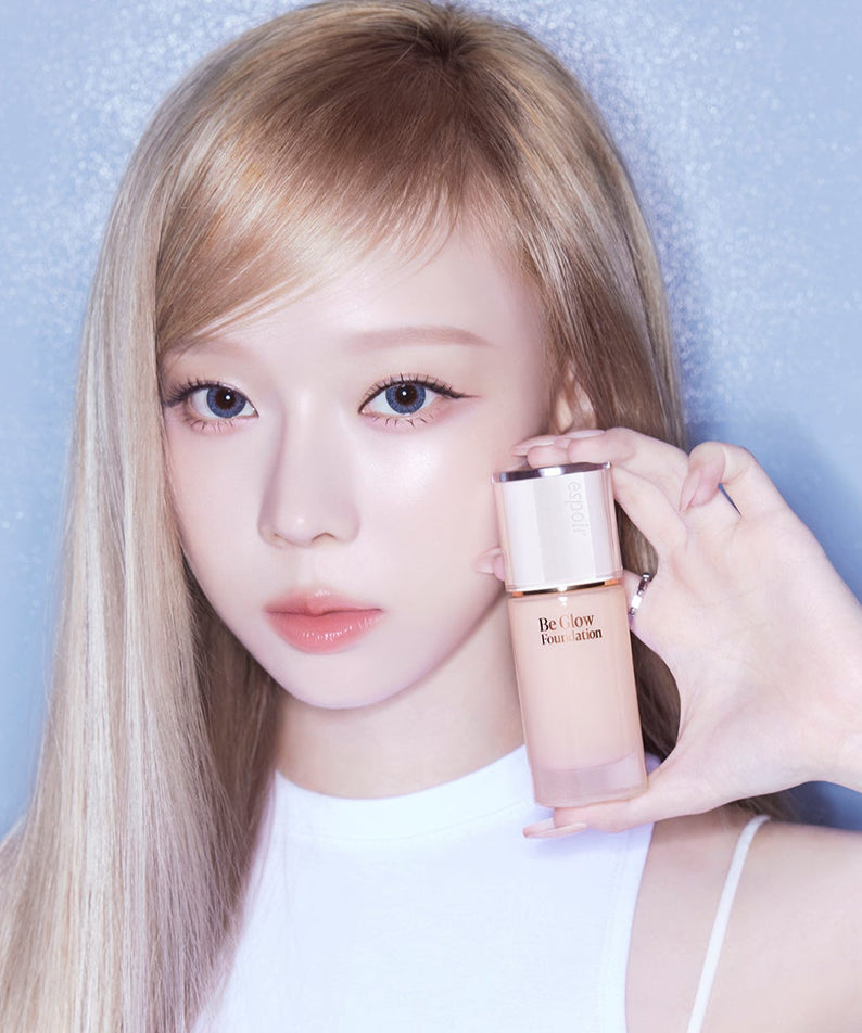 Model holding ESPOIR BE GLOW FOUNDATION SPF27 PA++ showcasing its radiant coverage