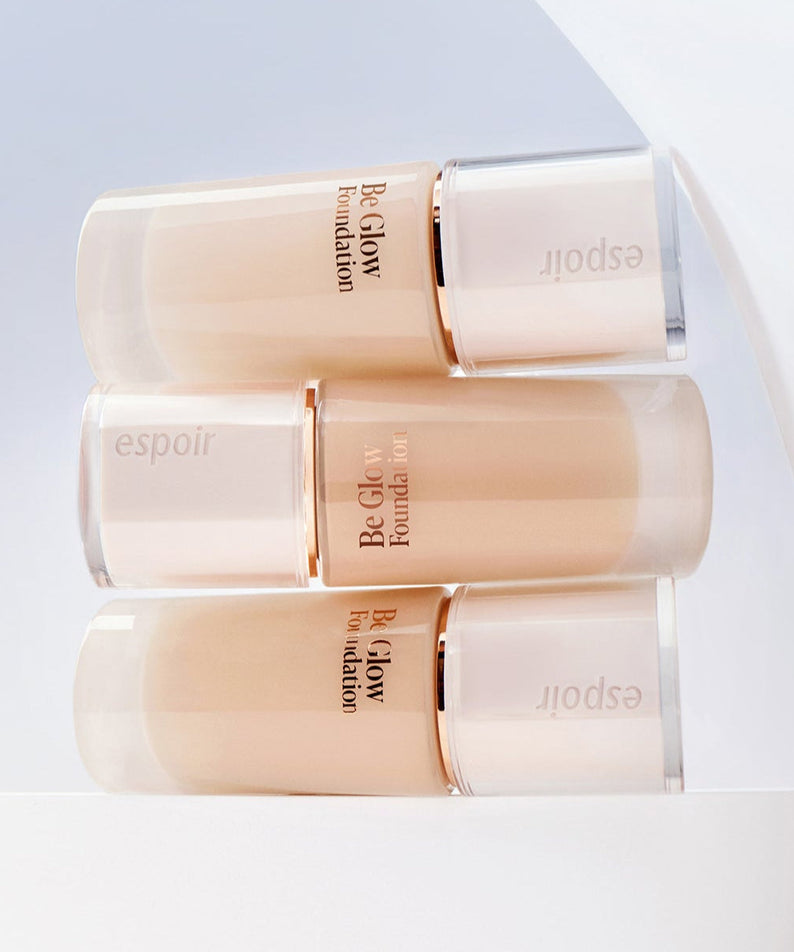ESPOIR BE GLOW FOUNDATION SPF27 PA++ bottles in a stylish display on a white backdrop.