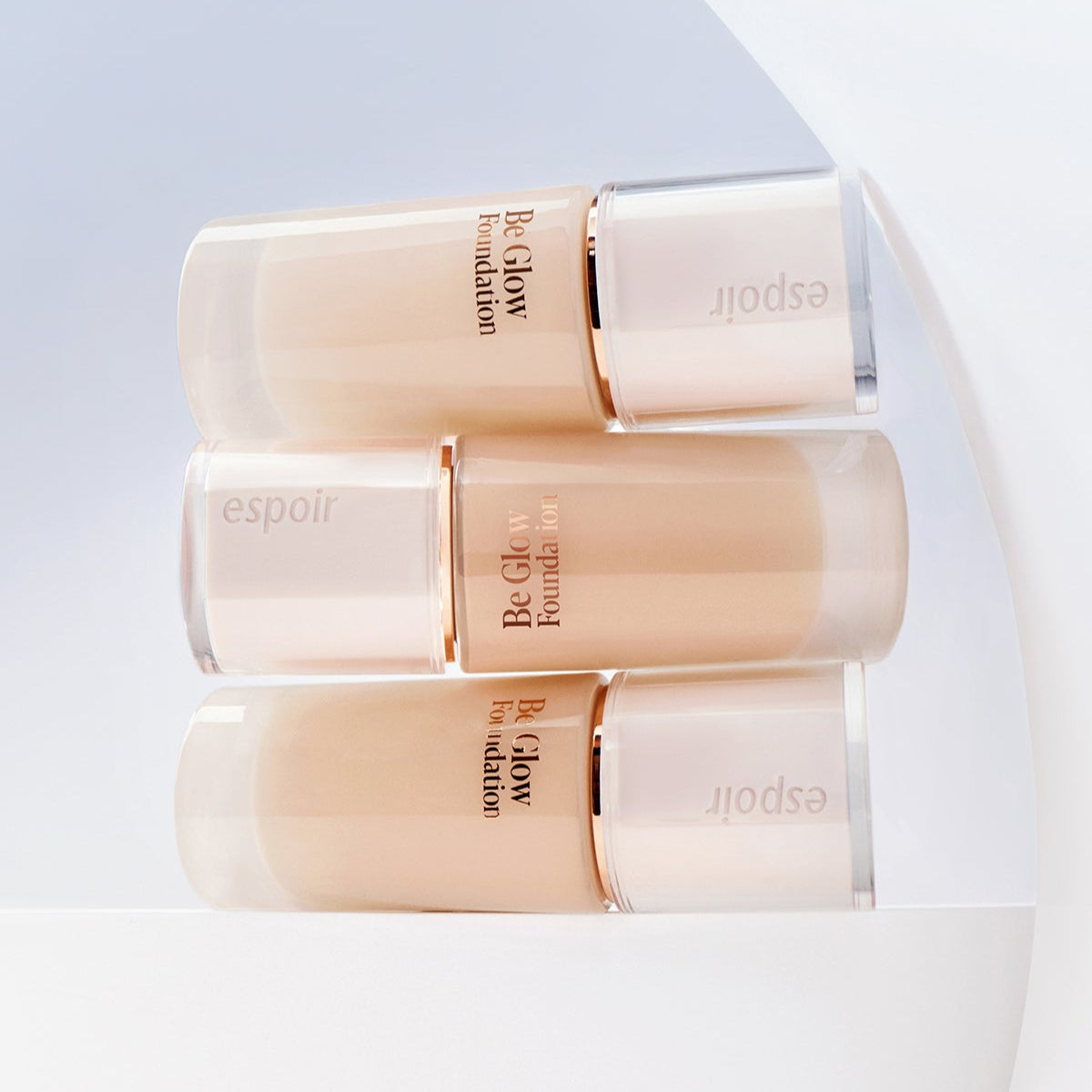 ESPOIR BE GLOW FOUNDATION SPF27 PA++ bottles in a stylish display on a white backdrop.