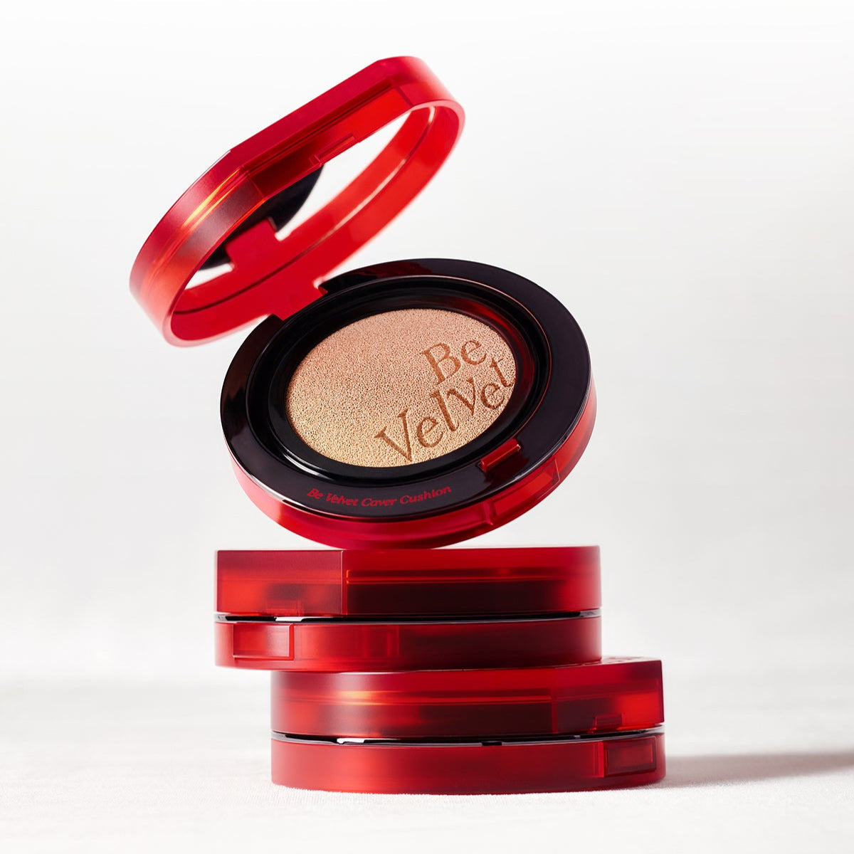 Red ESPOIR BE VELVET COVER CUSHION SPF42 PA++ compact open showing product, stacked with closed compacts on white background.