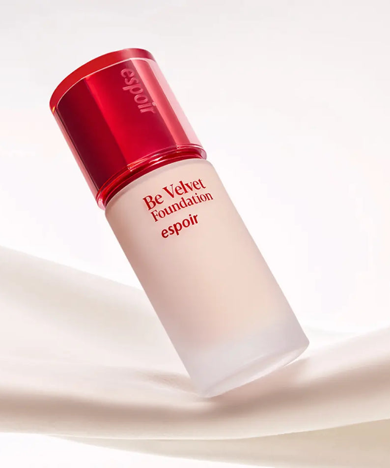 ESPOIR BE VELVET FOUNDATION SPF22 PA++ bottle on a silky fabric background